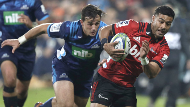 Battle of the five-eighths: Richie Mo'unga races past Harry Plummer in Christchurch.