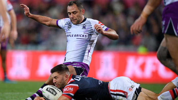 Storm captain Cameron Smith and James Tedesco compete for the ball during the NRL preliminary final between Melbourne and the Sydney Roosters.   
