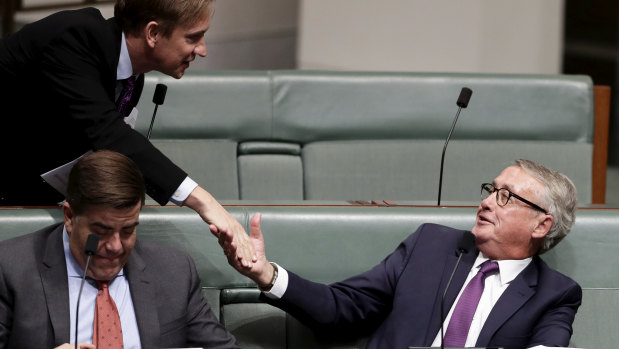 Labor MP Julian Hill shakes Mr Swan's hand during question time on Monday.
