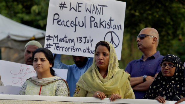 Members of a civil society group condemn a suicide bombing in Islamabad on Saturday in Pakistan\'s troubled election campaign.