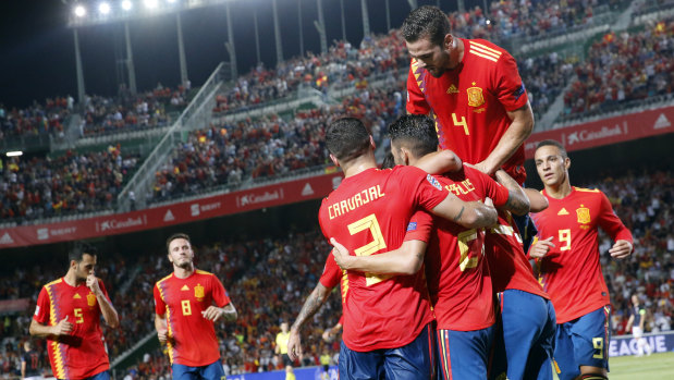 Sergio Ramos celebrates with teammates after scoring Spain's fifth goal.