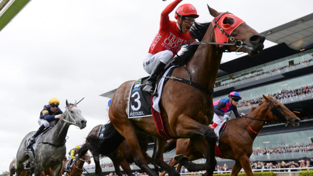 Jockey Kerrin McEvoy on Redzel raises his arm at the finish line as they win The TAB Everest race during The TAB Everest race day at Royal Randwick Race Course,