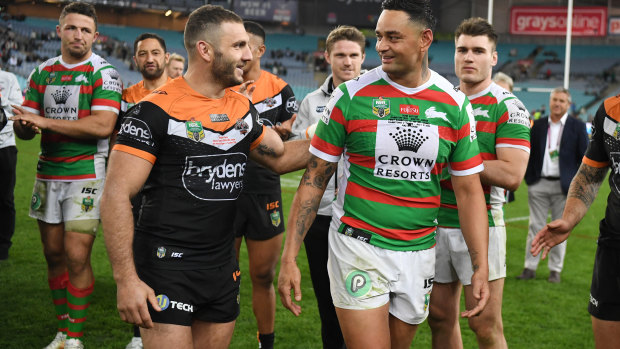 Milestone men: Robbie Farah and John Sutton share a moment at full-time.