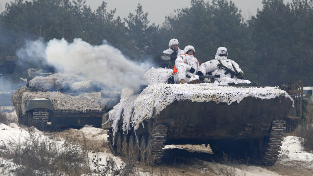 Ukrainian soldiers move to position during military drills in base Honcharivske, Chernihiv region, Ukraine, Monday.