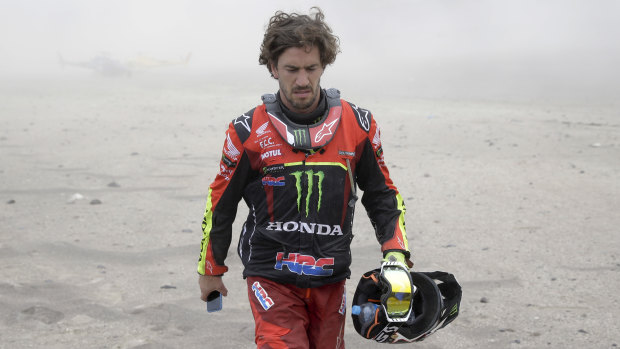 Joan Barreda walks away after crashing his Honda bike in the Dakar Rally.