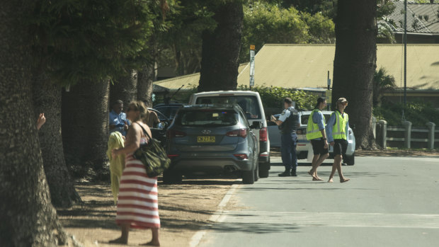 Police pull over a car on Ocean Road at Palm Beach. The government has asked that people stay at their primary residence over the Easter long weekend due to the coronavirus. 