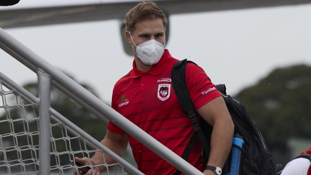 Jack de Belin boards a flight to Queensland with his Dragons teammates on Wednesday.