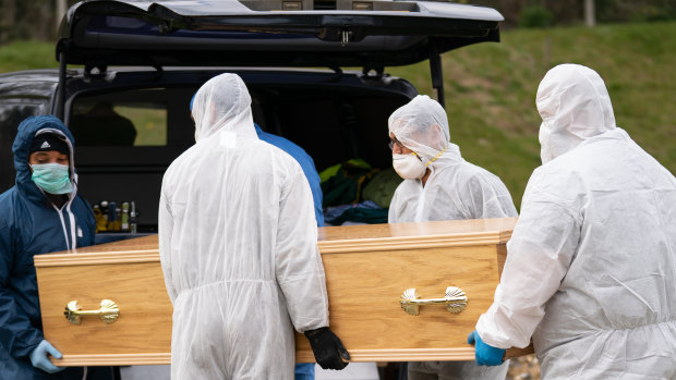 Undertakers wearing personal protective equipment carry the coffin of Ismail Mohamed Abdulwahab, 13, who died alone in Kings College Hospital after testing positive for the coronavirus.
