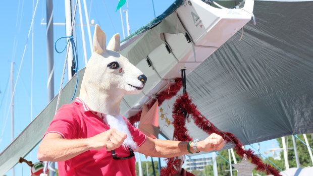 Gift giving: German skipper Freidrich Boehnert dons a kangaroo mask provided by Santa aboard his yacht Lunatix.