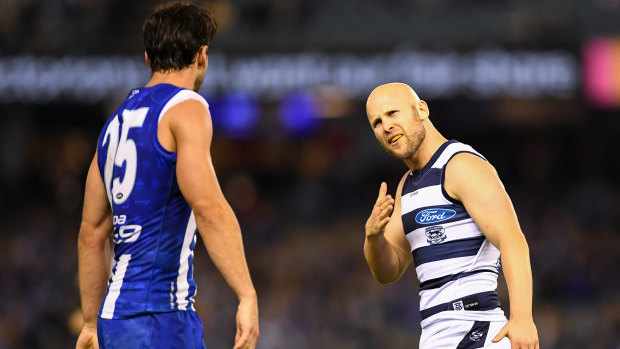 Gary Ablett (right) has words with North Melbourne defender Robbie Tarrant.