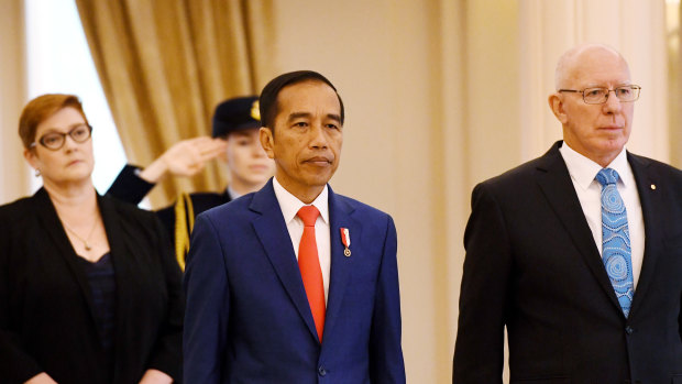 Governor-General David Hurley, right, greets Indonesian President Joko Widodo as he receives a ceremonial welcome. 