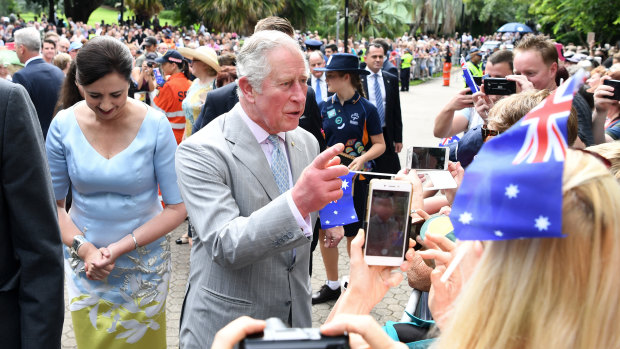 Prince Charles (centre), escorted by Queensland Premier Annastacia Palaszczuk (left), is greeted by public during a visit to Brisbane.