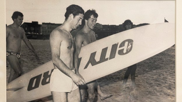 Prince Charles at Bondi in 1977, alongside a surfboard emblazoned with the name of Nick Politis’ car dealership.