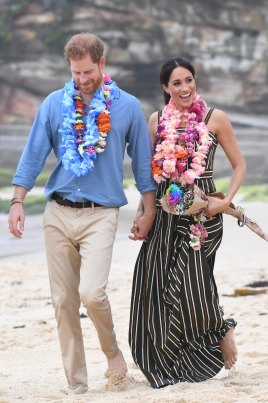 Britain's Prince Harry, the Duke of Sussex and his wife Meghan, the Duchess of Sussex catch the beach vibe.