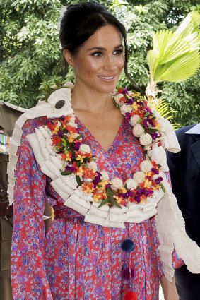 The Duchess of Sussex wore a silk Figue Frederica printed ruffle dress and a clutch bag of locally-made tapa barkcloth in Suva, Fiji.