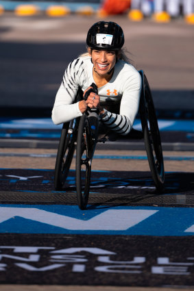 Female wheelchair champion Madison de Rozario crossing the line.
