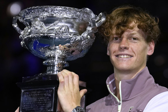 Jannik Sinner holds his Australian Open trophy.