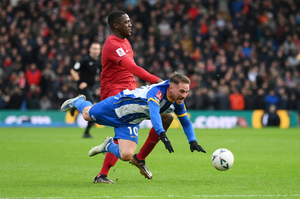 Brighton’s Alexis Mac Allister is challenged by Ibrahima Konate, of Liverpool.