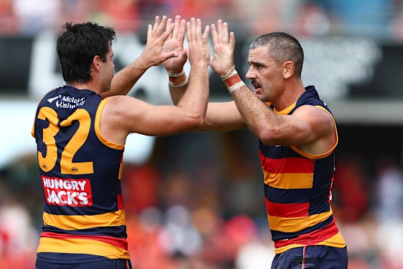Taylor Walker (right) celebrates a goal with teammate Darcy Fogarty.