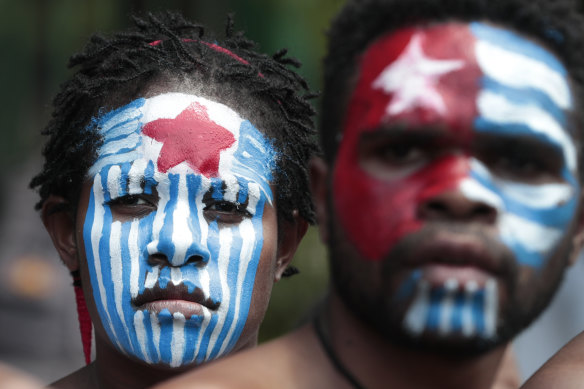 Papuan activists with their face painted in the colours of the separatist Morning Star flag rally in Jakarta last year.