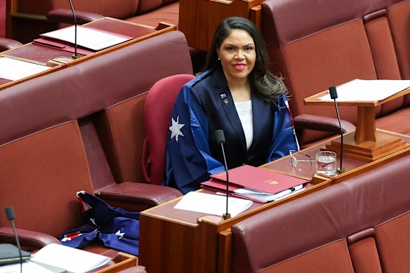 Senator Jacinta Nampijinpa Price draped in the Australian flag in the Senate on Wednesday.