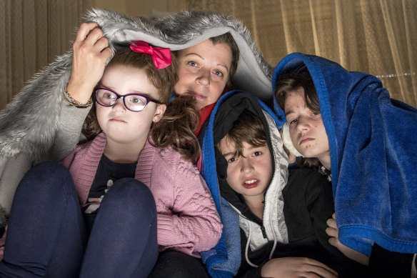 Alisha Bennett and three of her four children - Ava, 12, Lukas, 11, and Arabella, 5. They are waiting to have their heating fixed.