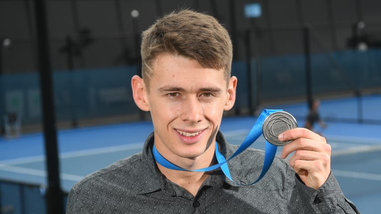 Alex de Minaur shows off his Newcombe Medal at Melbourne Park on Tuesday.