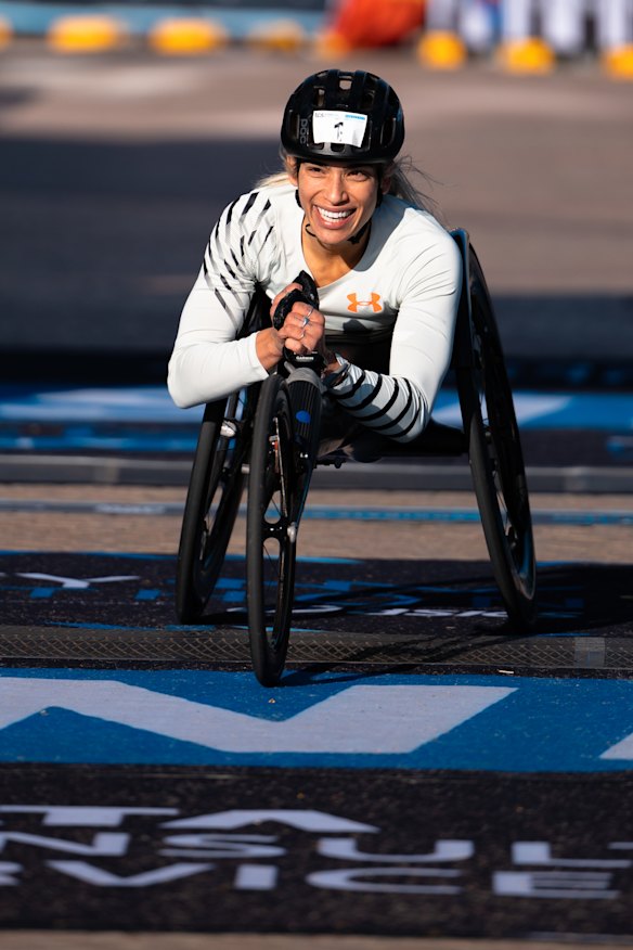 Female wheelchair champion Madison de Rozario crossing the line.