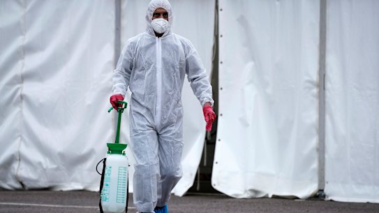 Specially trained volunteers work at a temporary morgue erected at a carpark at a mosque in Birmingham, England. More than 2.3 million people have been infected with coronavirus