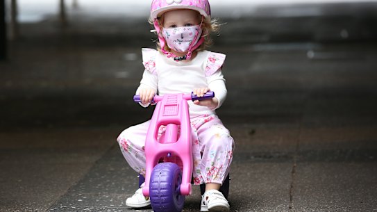 BRISBANE, AUSTRALIA - JANUARY 09: Elodie, a young resident, wears a mask as she rides her bike, on January 09, 2021 in Brisbane, Australia. According to reports, Queensland has recorded no new cases of coronavirus overnight as Brisbane residents remain under lockdown. Greater Brisbane is under a three-day lockdown until 6 pm on Monday, January 12 after a cleaner working at one of the city's quarantine hotels tested positive for a new variant of the Covid-19 strain that originated in the UK. (Photo by Jono Searle/Getty Images)