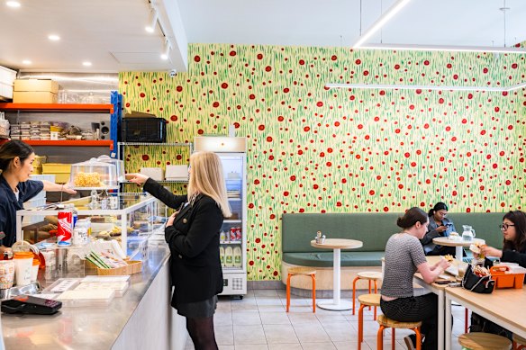 The cheerful interior of bakery-cafe Raya, a popular meeting place along Little Collins Street.