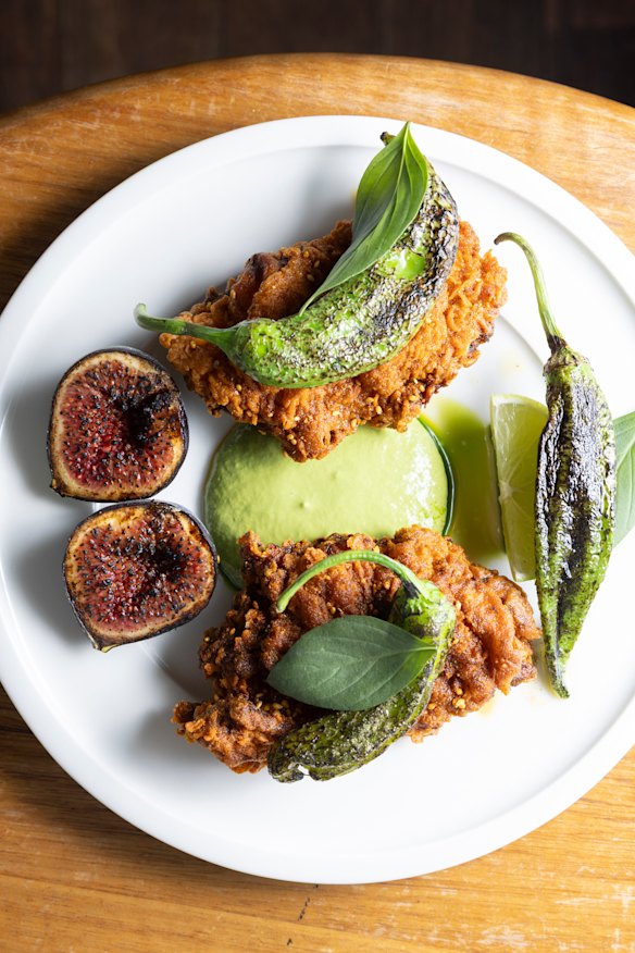 Fried chicken with spiced garlic butter, green goddess sauce and peppers. 