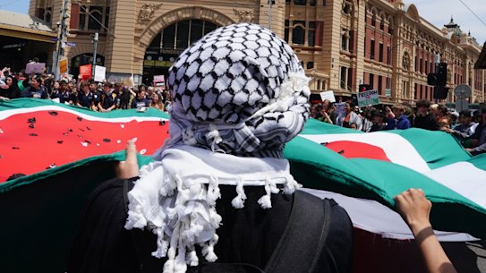 A protester in a keffiyeh at a pro-Palestinian student rally outside Melbourne’s Flinders Street Station.