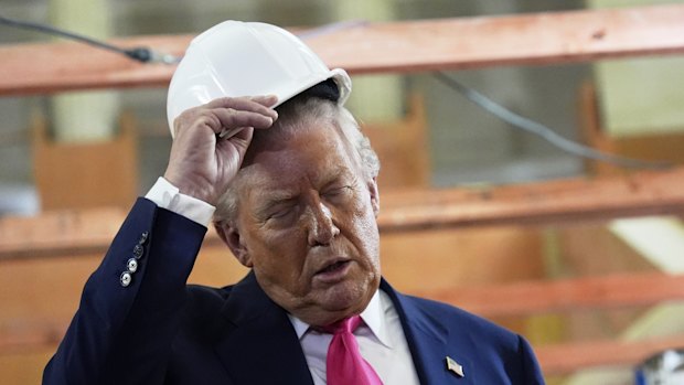 President Donald Trump, left, and Federal Reserve Chairman Jerome Powell visit the Federal Reserve, Thursday, July 24, 2025, in Washington. (AP Photo/Julia Demaree Nikhinson)