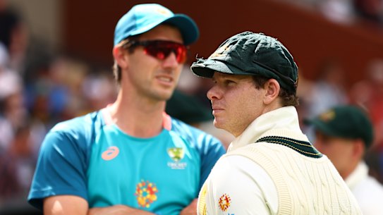 Pat Cummins with Steve Smith.