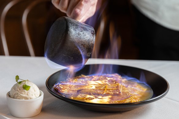 Crepes suzette are flamed in Grand Marnier at the table.