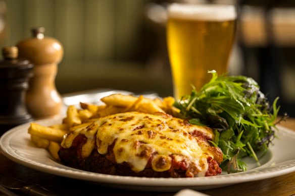 The free-range chicken parma is topped with ham from Ballarat’s Salt Kitchen Charcuterie carved off the bone in the kitchen.