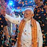 Prime Minister Narendra Modi (centre) waves to supporters celebrating the BJP’s victory in the recently held state assembly elections.