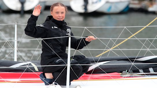 ​Greta Thunberg waves to her supporters on her arrival in New York aboard the zero-emissions yacht Malizia II on Wednesday. 