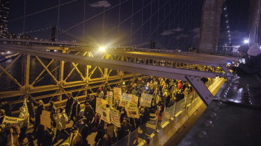 Demonstrators march across the Brooklyn Bridge in New York, following the acquittal of Kyle Rittenhouse.