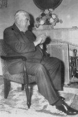 The Prime Minister, Sir Robert Menzies, jokingly applauding himself while watching his own policy speech on television. 
