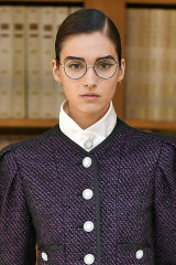 Model Rachelle Harris wearing winged eyeliner and lashes under glasses at the Chanel Paris Haute Couture Week show in July.