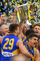The Eagles celebrate with the 2018 premiership cup.