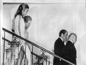 Mrs McMahon and Mrs Nixon follow their husbands downstairs at the White House.