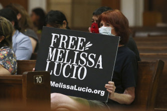 Rachelle Zoca holds a sign during a vigil for Melissa Lucio at the Basilica Of Our Lady of San Juan del Valle National Shrine, Friday in San Juan, Texas.