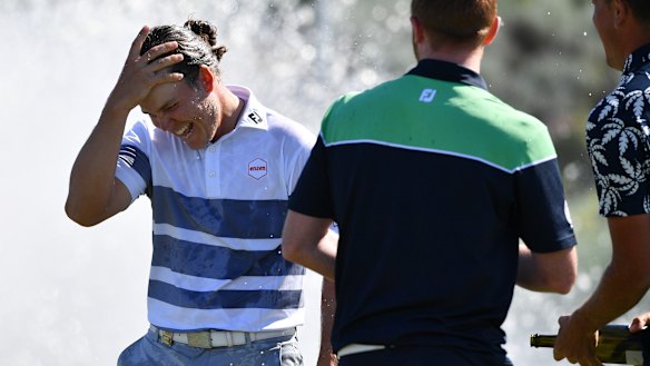 Winner: Jake McLeod is sprayed with champagne on the 18th green.