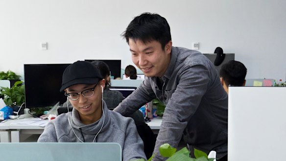 Peng Zehuan, right, co-founder of FEED Tech, with a colleague in their office in Beijing.
