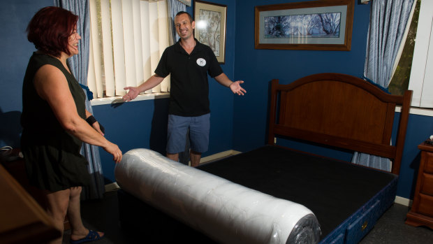Bibi Amsteins and Ben Riddles set up her new mattress.