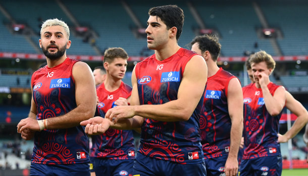 Christian Salem and Christian Petracca and their Demons teammates look dejected after losing in round 11.