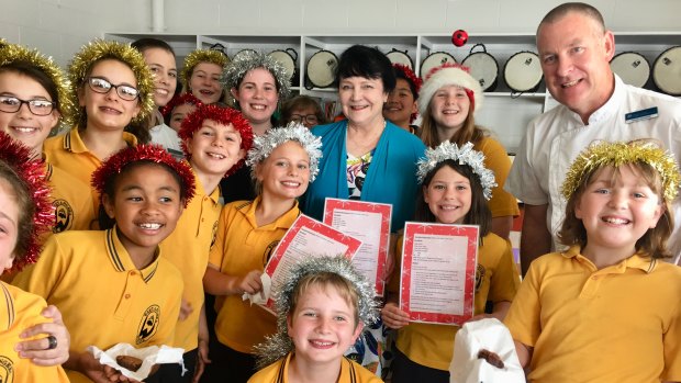 Executive Chef at Parliament House David Learmonth (right) with Weetangera Primary School choir leader Jan Lloyd-Jones (centre), APH Pastry Chef Amanda Polsen (third from left) with choir members. 